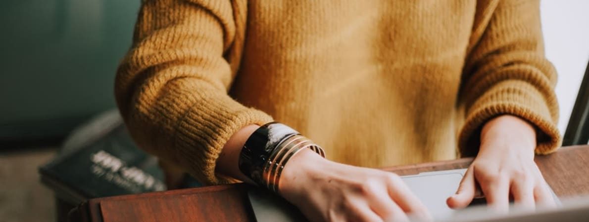 Photo of woman typing on laptop