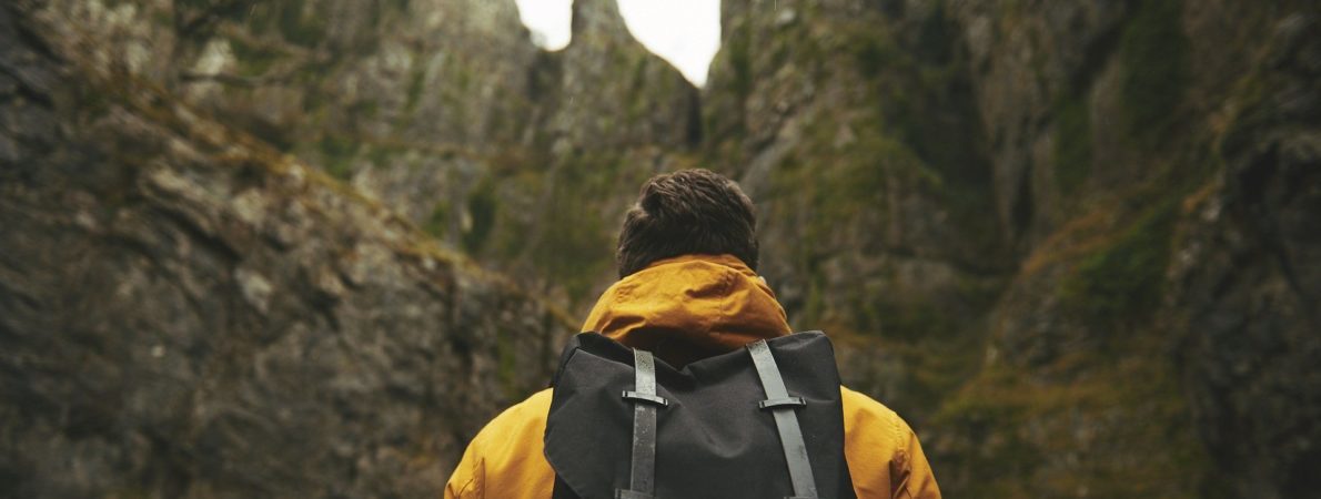 mage shows man with a backpack walking in the mountains