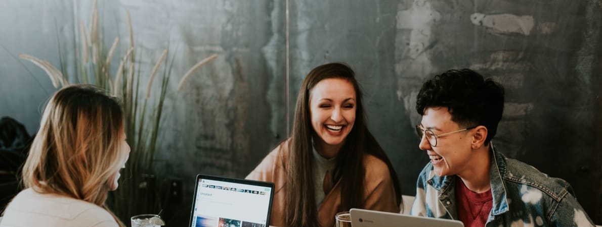 Photo of three students studying together with laptops