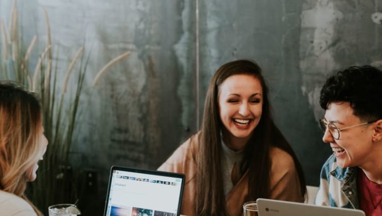 Photo of three students studying together with laptops