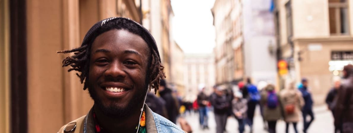 Photo of young person smiling in street