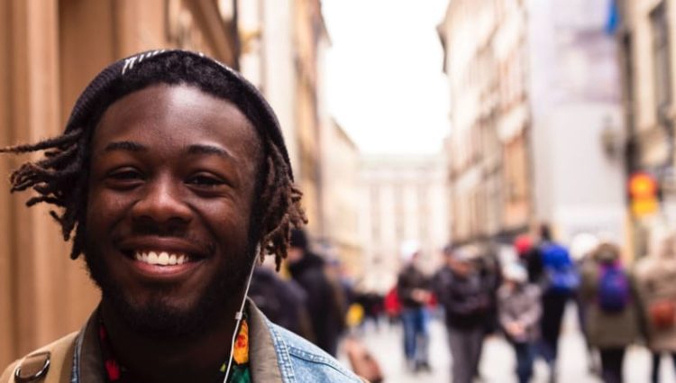 Photo of young person smiling in street