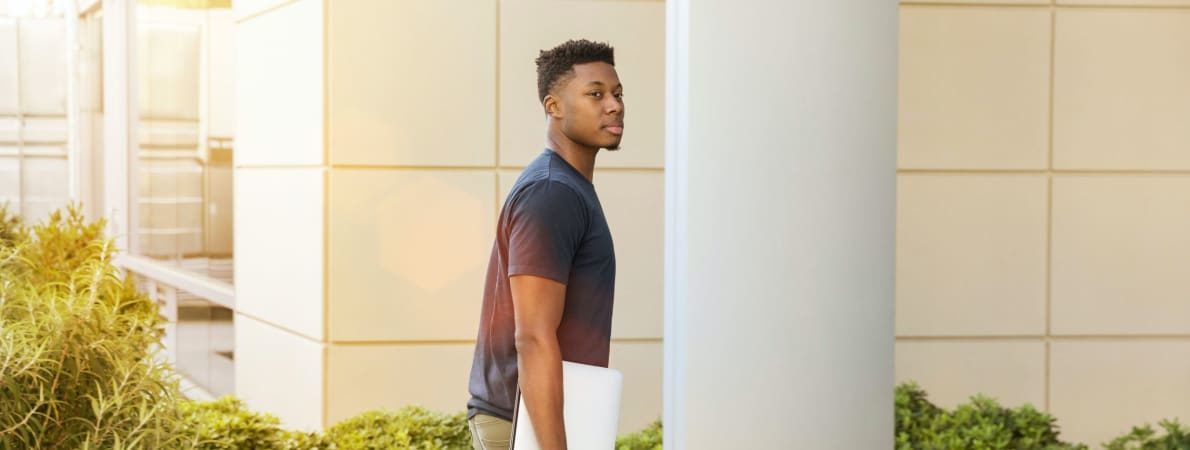 Photo of student entering campus building