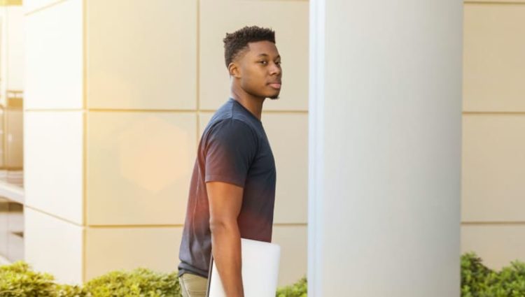 Photo of student entering campus building