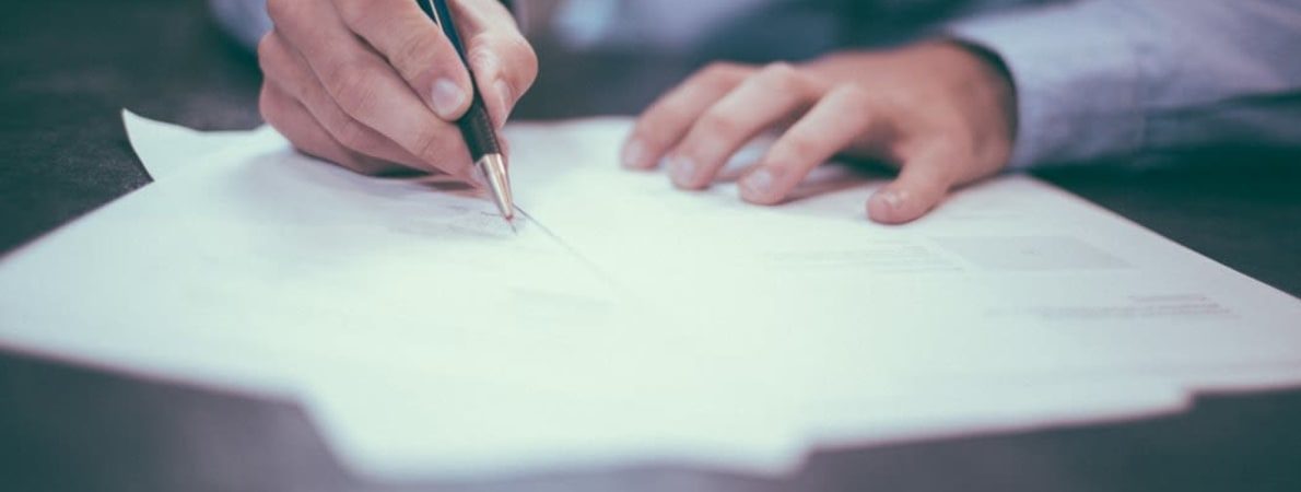 close up picture of a person writing on paper