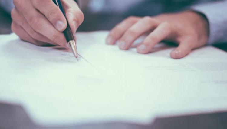 close up picture of a person writing on paper