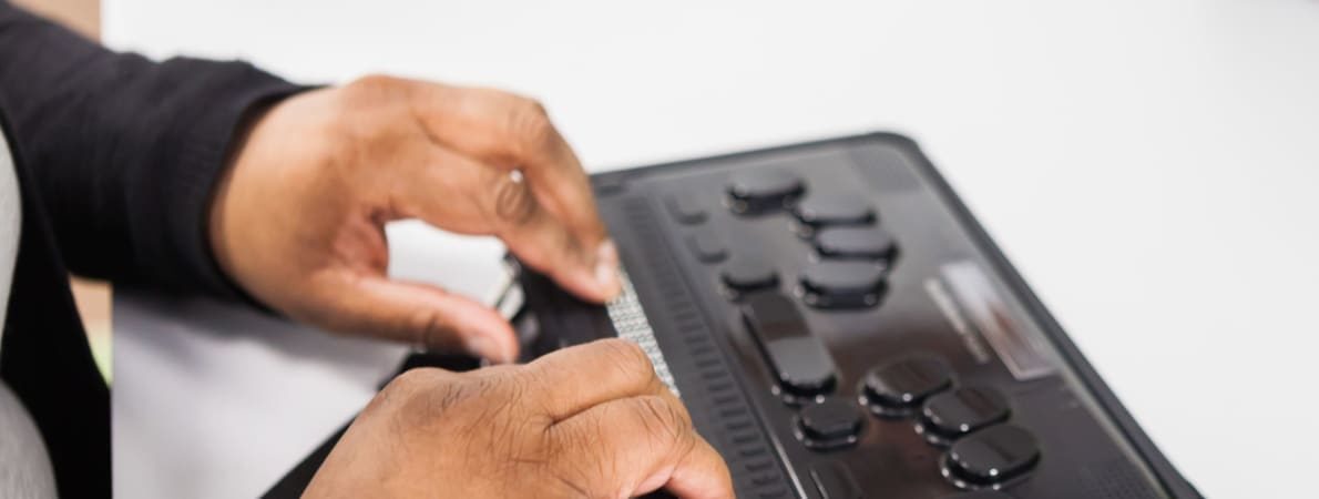 Photo of man using an assistive technology device.