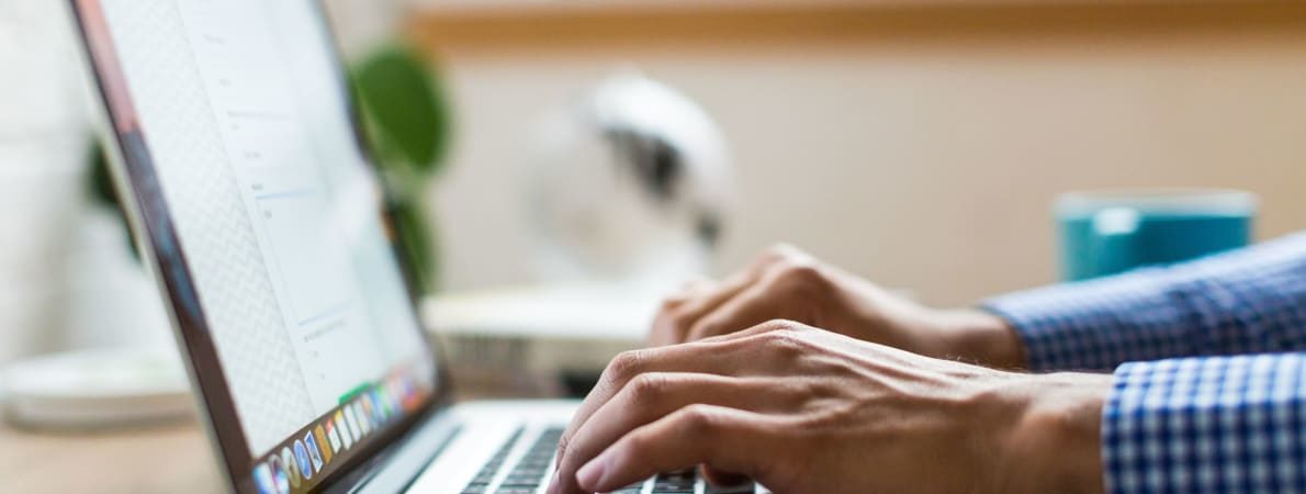 Photo of hands on laptop keyboard