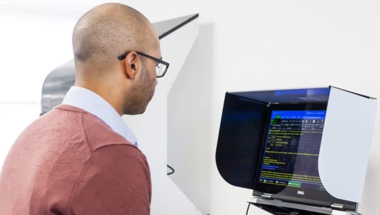 Man working on a computer standing.