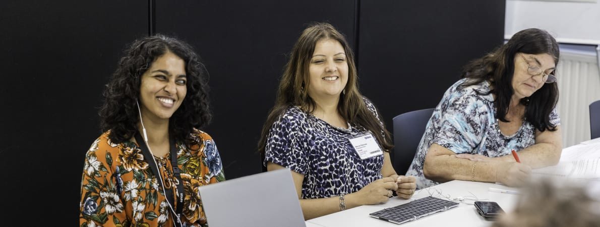 People in a meeting smiling