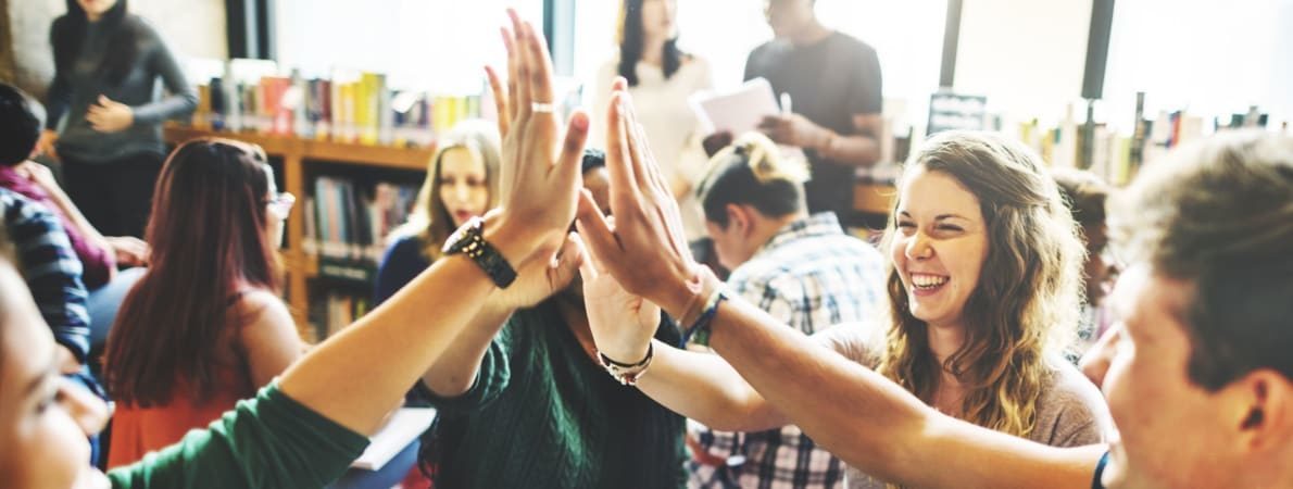 Students holding hands up to high-5