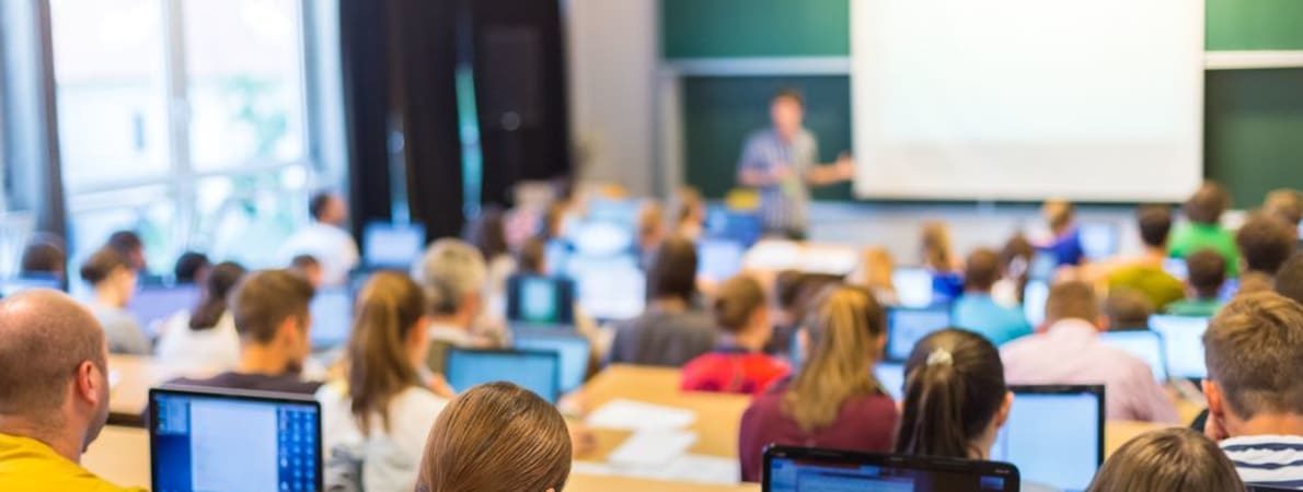 Student support page banner showing people sitting in classroom
