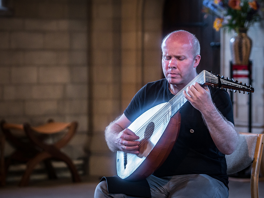 Shot of Matt playing the lute