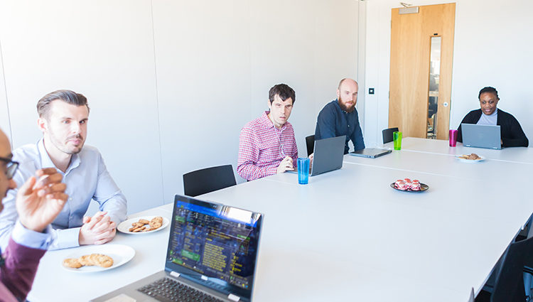 Group of TPT staff sat round a board table