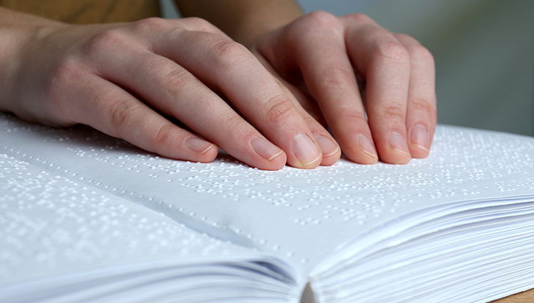 Blind woman reading braille