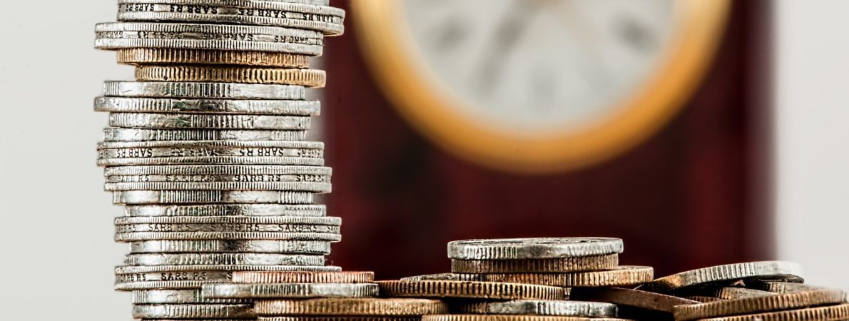 Money coins stacked in pile on the table