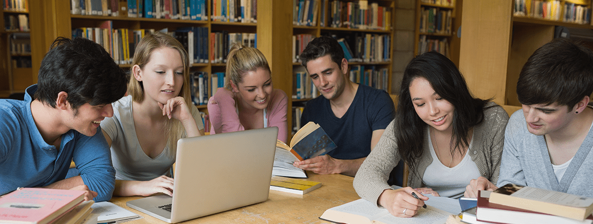 Group of students reading in the library