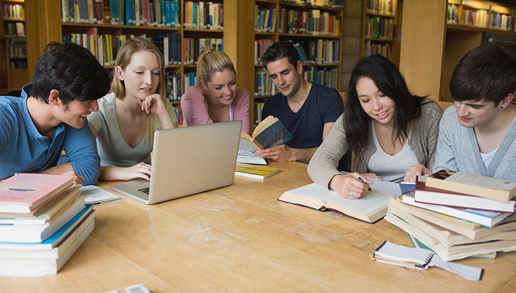 Group of students reading in the library