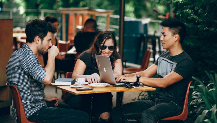 Three students sitting around a table