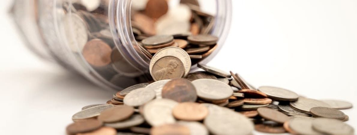 Jar on its side with coins spilling out