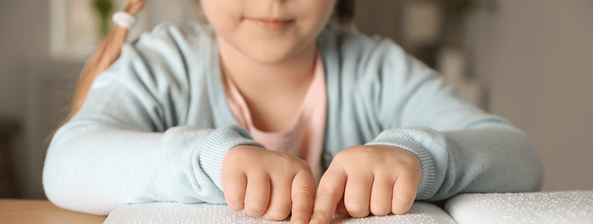 Blind child reading braille