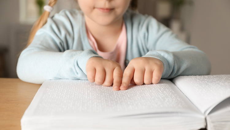 Blind child reading braille