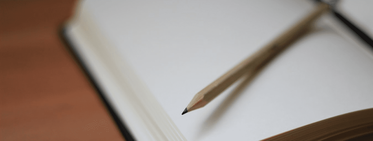 Close up of a pencil and notepad