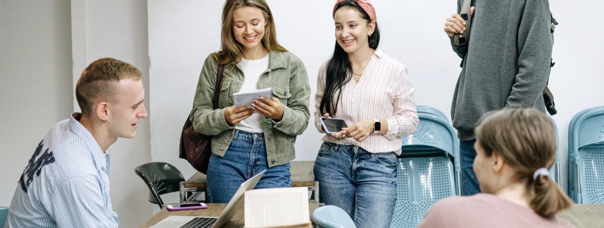 Five students sitting around a table studying