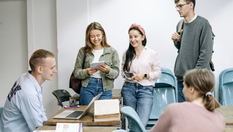 Five students sitting around a table studying