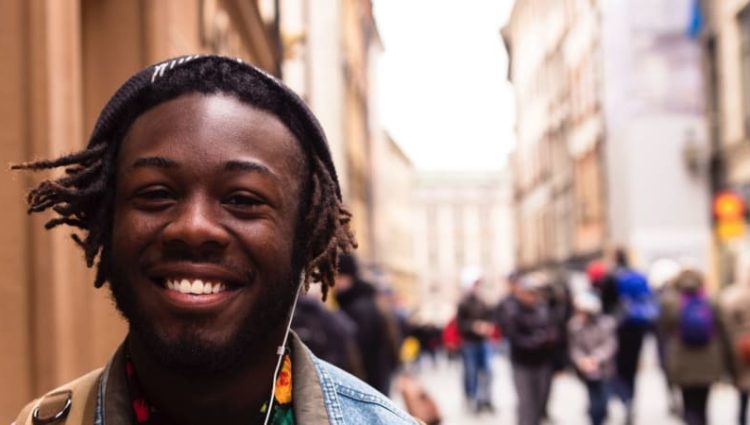 Photo of young person smiling in street