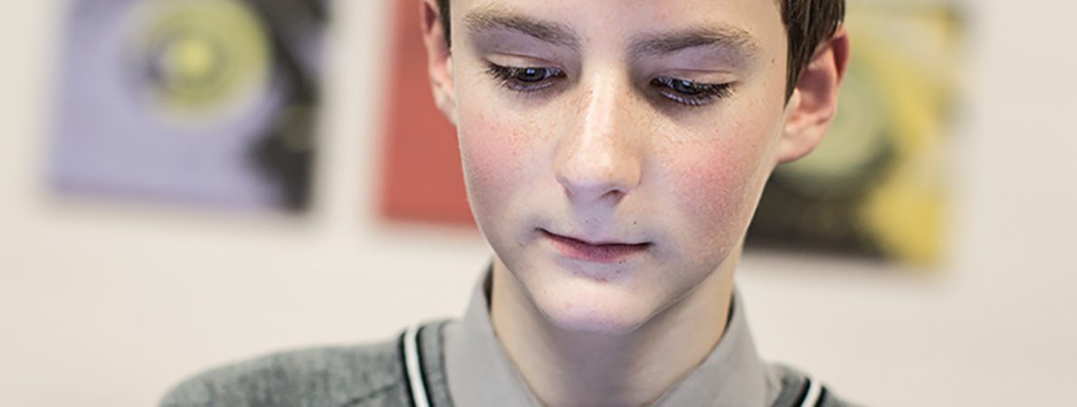 Close-up of a young boy using tablet