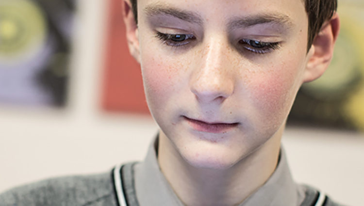 Close-up of a young boy using tablet