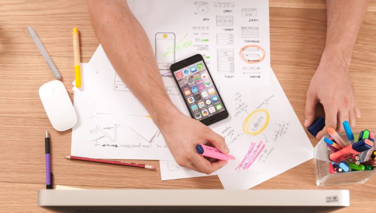 Man writing notes on white paper