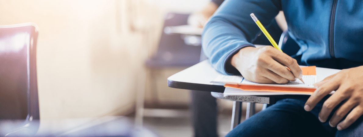 Out of focus student holding pencil