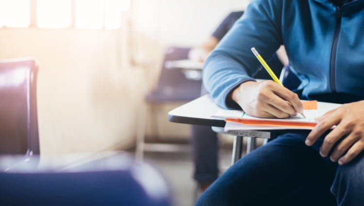 Out of focus student holding pencil