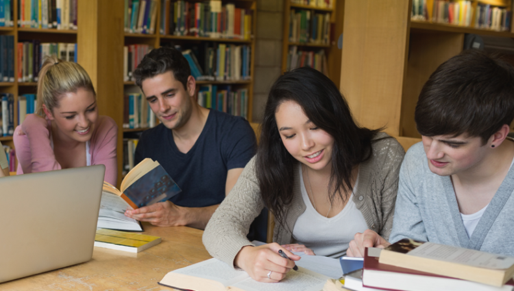 Group of students in the library reading