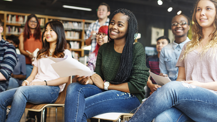 Students sitting in the class smiling