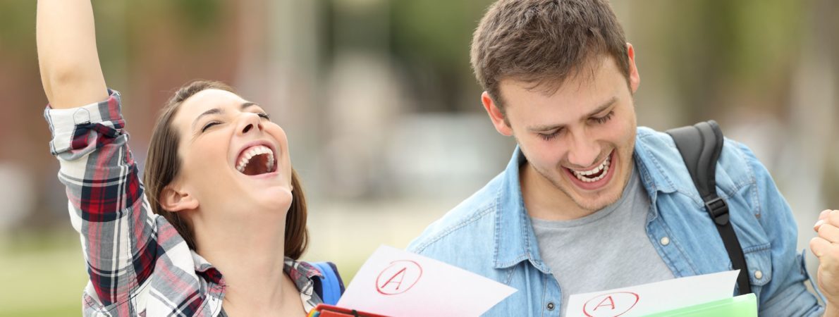 Two students celebrating after receiving their grades