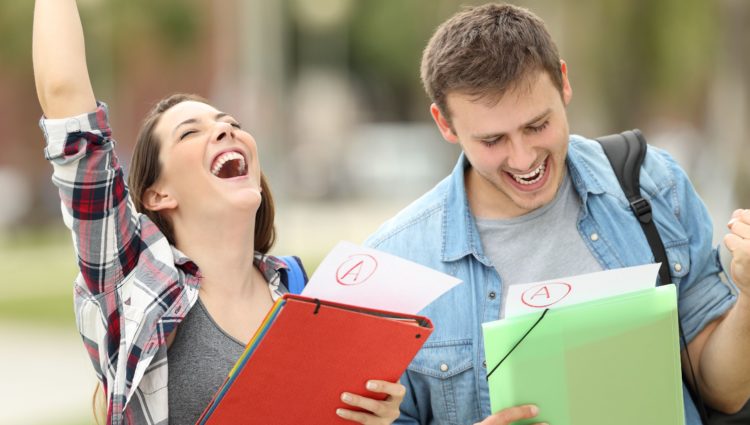 Two students celebrating after receiving their grades