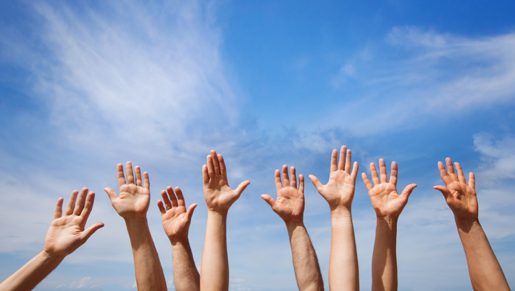 hands of a group of people in the air