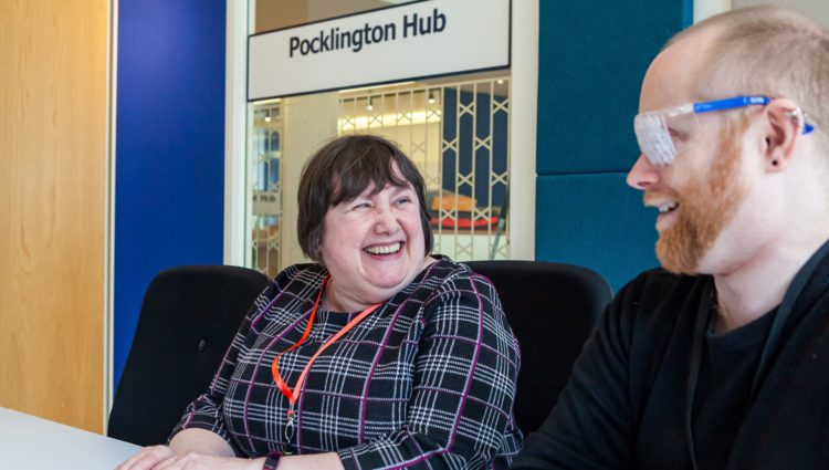 Two members of staff in a meeting launching