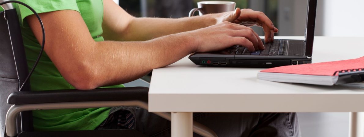 Disabled student in a wheelchair working on a laptop