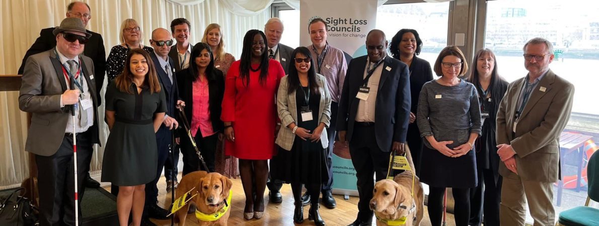 A large group photo of volunteers and MPs in Westminster.