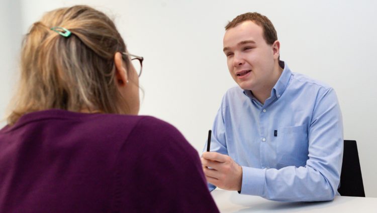 a visually impaired person chatting to a woman