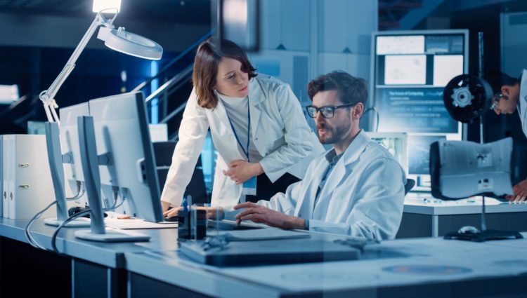 A woman and a man working in a lab