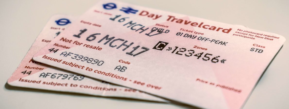 A pair of travel tickets sit atop a table