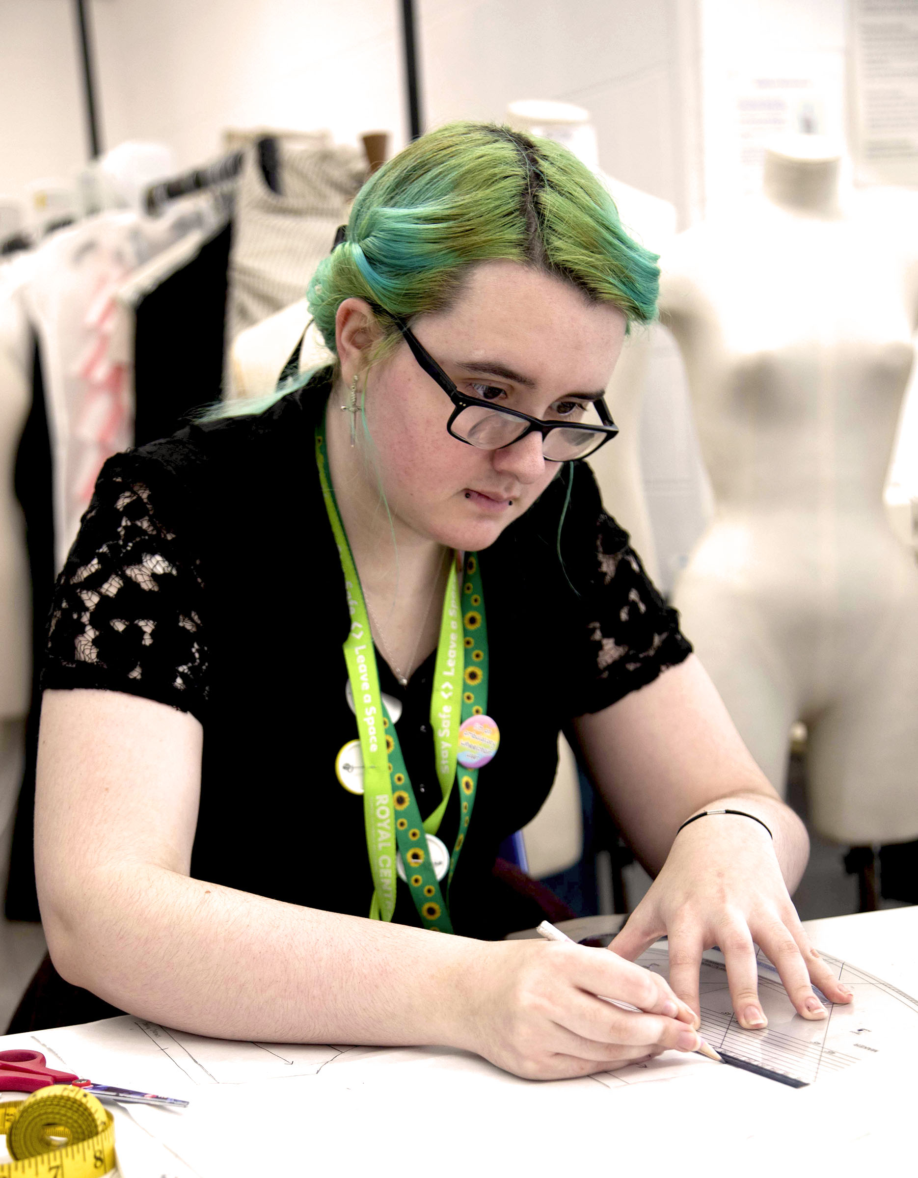 close-up picture of Rowan sketching while sitting on a chair