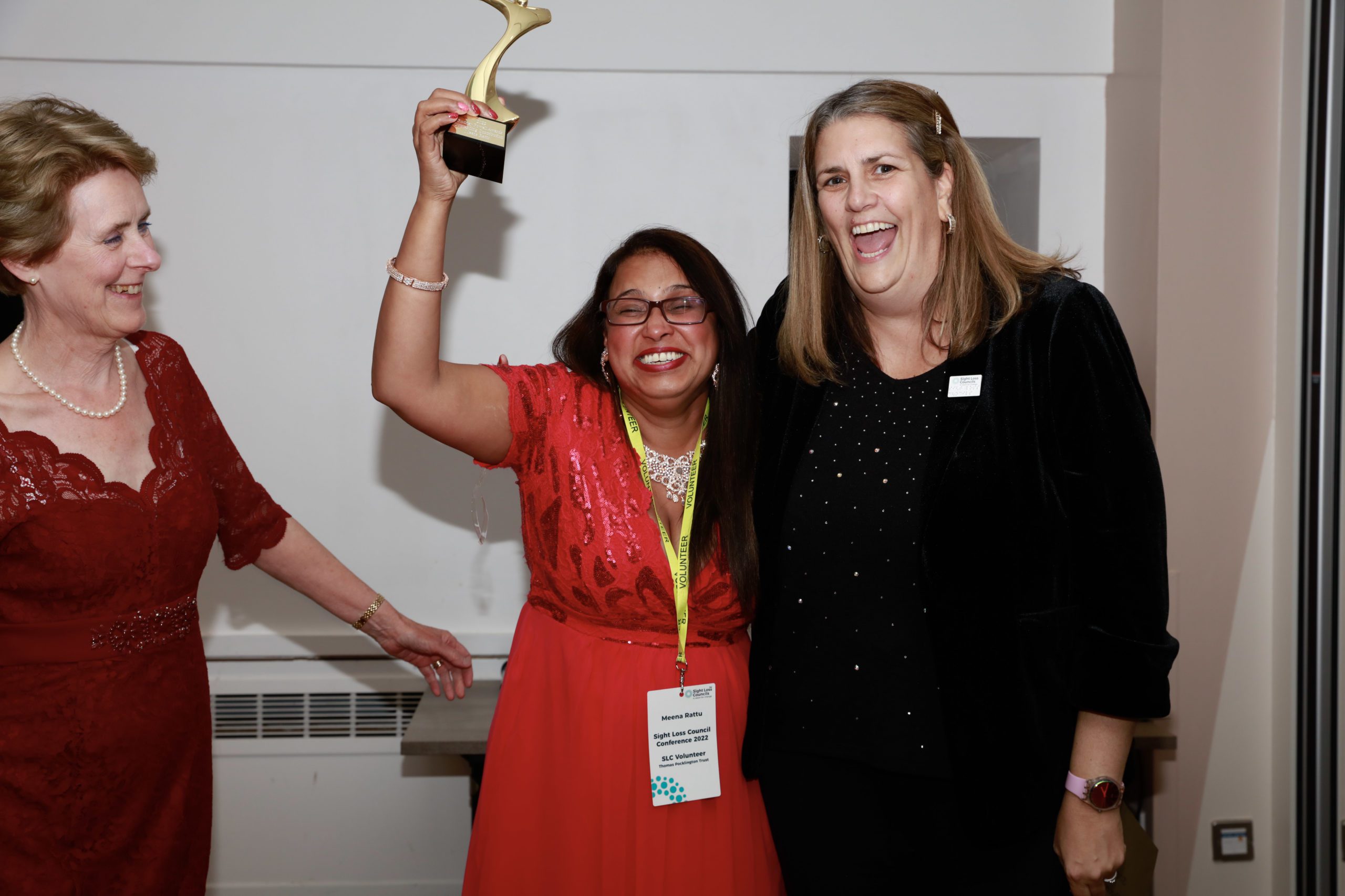 Meena Ratu with Emma Hughes and a SLC member holding her trophy and smiling at the camera