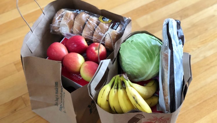 Bag full of groceries including fruit and vegetables