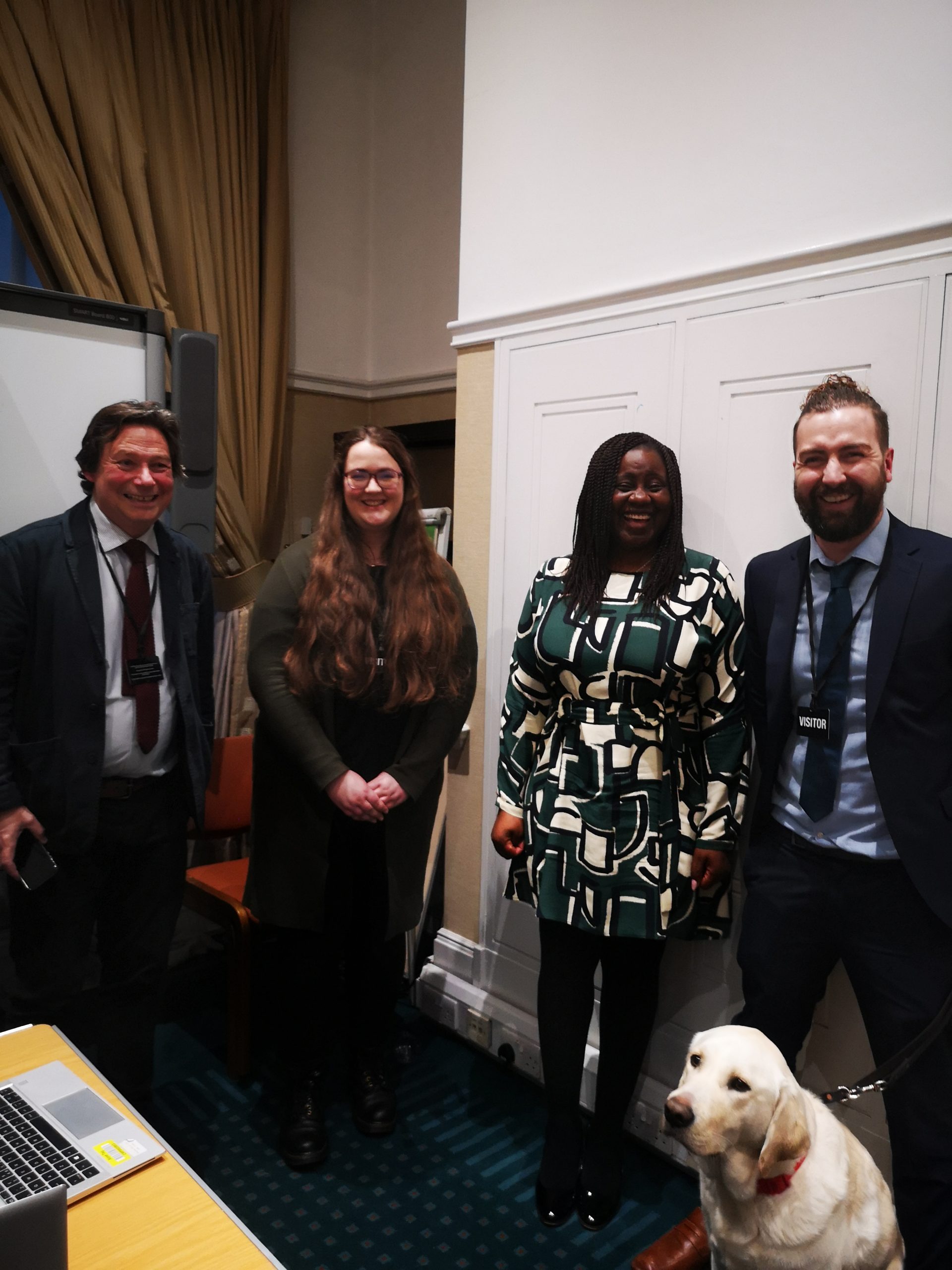 Picture showing Jeff Page, Margaret Hart, MP Marsha De Cordova and Josh Feehan with his guide dog Ringo looking at the camera and smiling